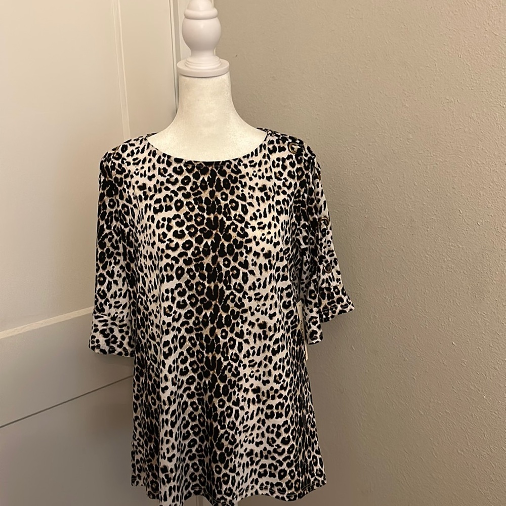 Animal print top with ruffle sleeves w/ gold cross cross design